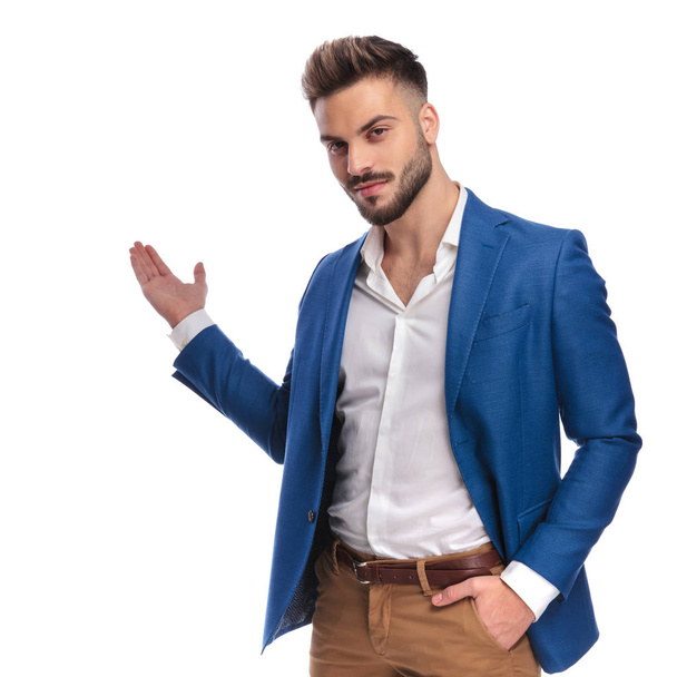latin guy in suit inviting with hand in pocket - Photo, Image