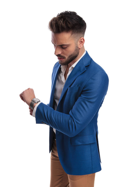 cool guy in suit checking time on his watch - 写真・画像