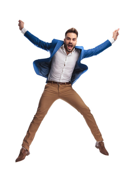 cool man jumping and screaming with hands in the air - Photo, Image
