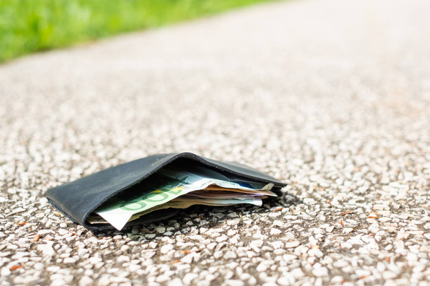 Wallet with money drop on the street and lost - Photo, Image