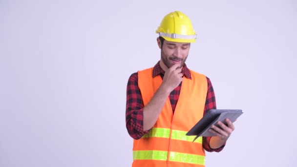 Happy bearded Persian man construction worker using digital tablet and giving thumbs up - Felvétel, videó