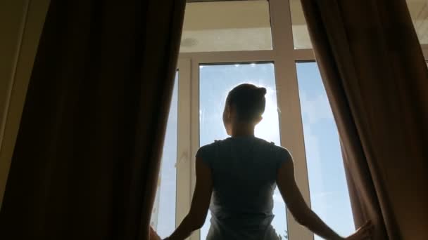 Woman opening window curtains - Footage, Video