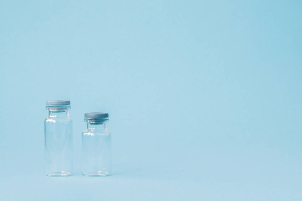 Vial of medicine on blue background with copy space. Antibiotic  - 写真・画像