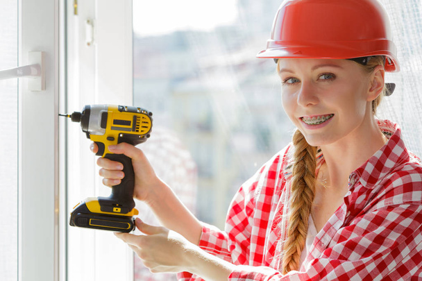 Girl using some power tools for work at home - Foto, Imagen