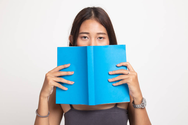 Young Asian woman with a book cover her face. - Valokuva, kuva