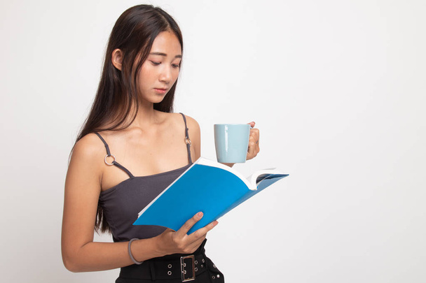 Young Asian woman with a book and cup of coffee. - Φωτογραφία, εικόνα