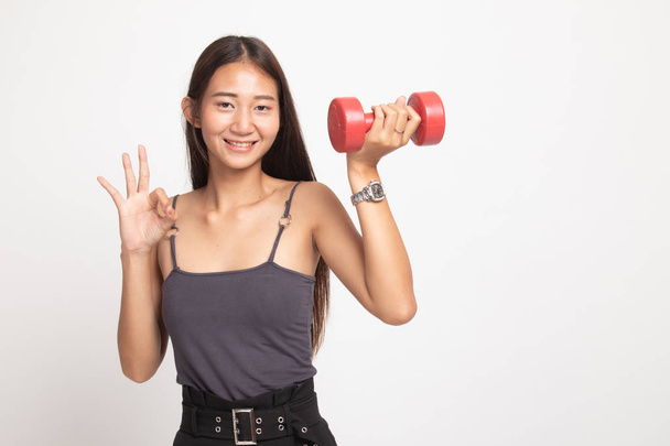 Healthy Asian woman show OK with dumbbells. - 写真・画像