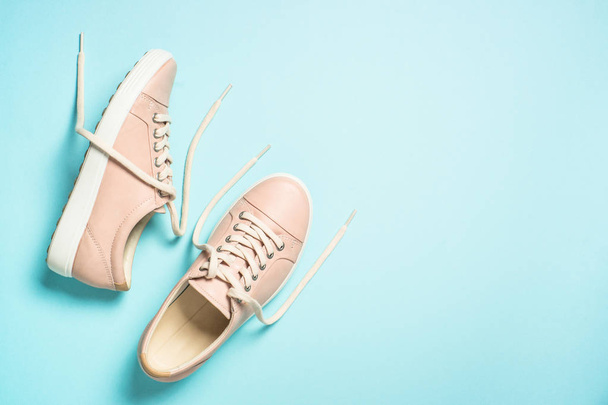 Woman fashion pink shoes on blue background. - 写真・画像