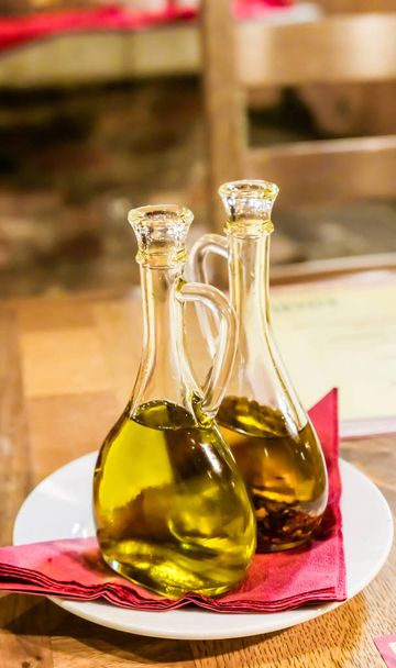 Bottles of organic extra virgin olive oil in Italian restaurant - Photo, Image