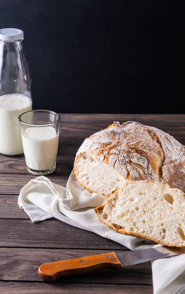 Freshly baked bread with milk rustic composition - Фото, зображення
