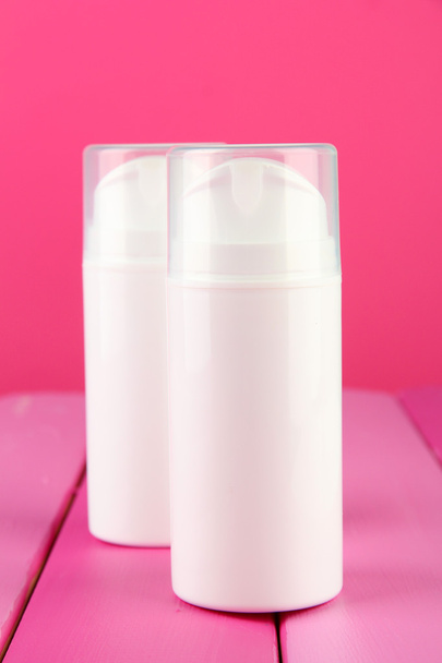 Bottle with cream, on color background - Zdjęcie, obraz