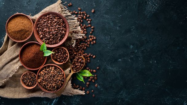 Ground coffee and coffee beans. Assortment of coffee varieties on a black background. Top view. Free space for your text. - Foto, imagen