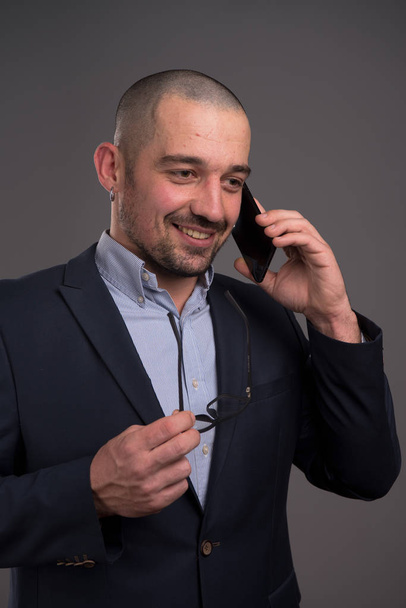 Excited manager actively discussing business matters over mobile phone - Фото, зображення