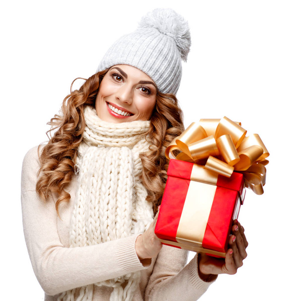 Beautiful young woman in knitted woolen sweater smiling holding gift boxes - Zdjęcie, obraz