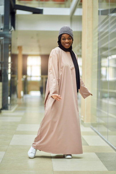 Beautiful young Muslim woman in business centre posing at camera - Fotoğraf, Görsel