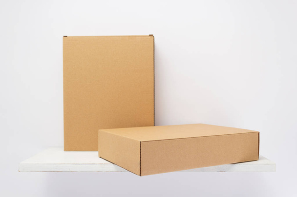 cardboard box on wooden shelf  - Valokuva, kuva