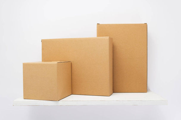cardboard box on wooden shelf  - Foto, imagen