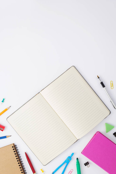 paper notebook and school supplies at white - Φωτογραφία, εικόνα