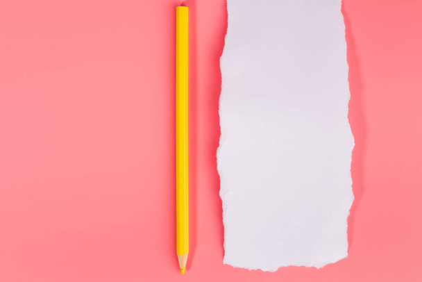 A piece of white torned paper over pink background with pencil - Fotografie, Obrázek