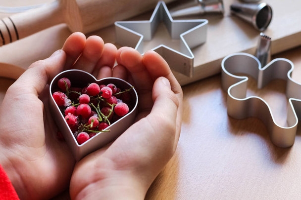 Kleine meisje hand maken traditionele feestelijke koekjes. Bakken met liefdes concept. Moederdag, vrouwen dag, Valentijnsdag. Top View - Foto, afbeelding