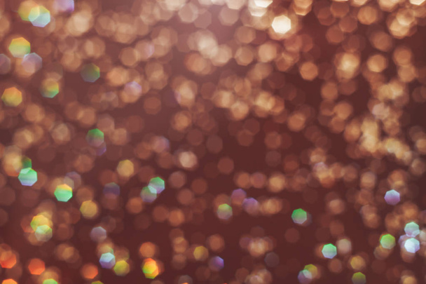 Beautiful gold bokeh on a brown background. - Foto, afbeelding
