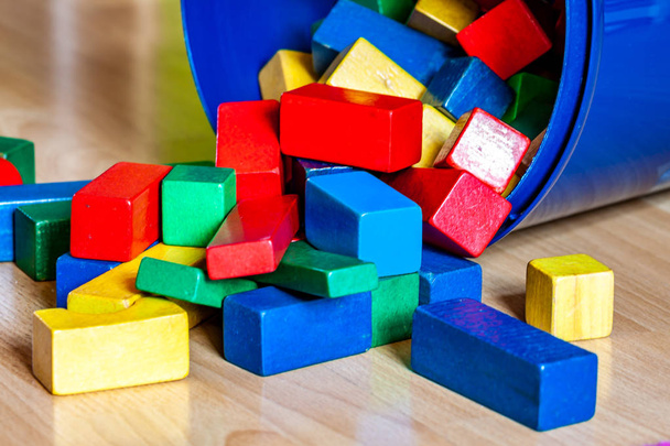 Colorful wooden building blocks on floor . Selective focus - Zdjęcie, obraz