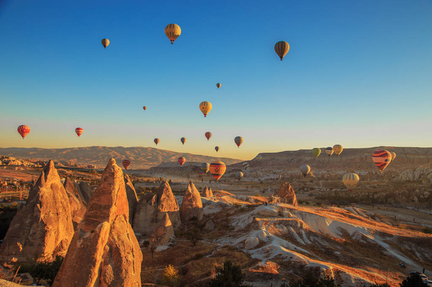 Amazing sunrise over Cappadocia. Colorful hot air balloons. - Фото, зображення