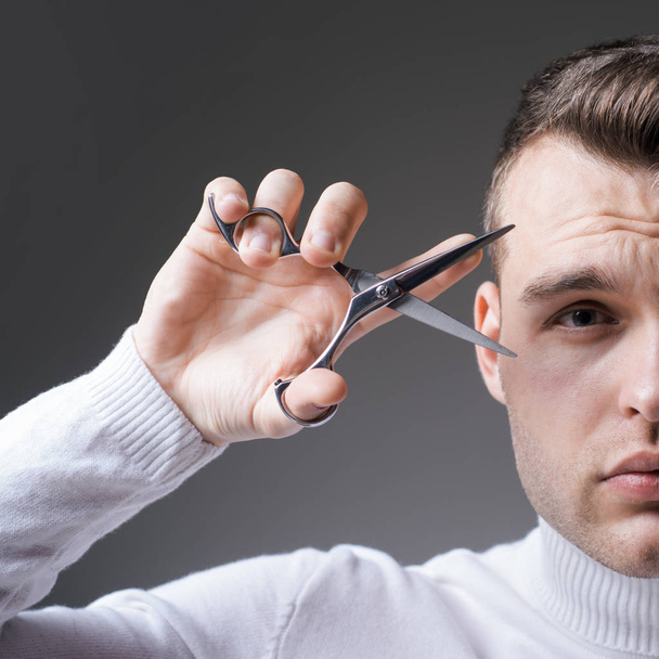 Cut hair. Man strict face hold scissors. Barber glossy hairstyle hold steel scissors. Create your style. Macho confident barber cut hair. Barbershop service concept. Professional barber equipment - Foto, imagen