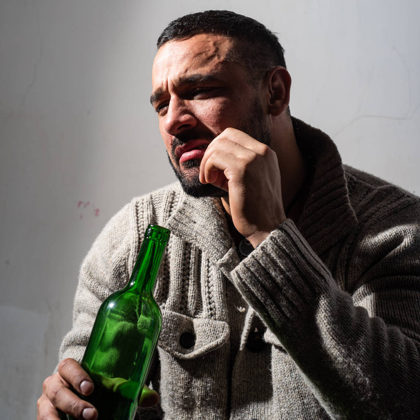 Alcohol addicted man. bachelor and single. lonely man drink wine from bottle. Sad depressed male adult has troubles with alcohol. addicted guy. concept of alcohol addicted. he is alcohol addicted - Фото, изображение