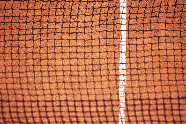 Sombra de red de tenis en campo de arena roja
  - Foto, Imagen