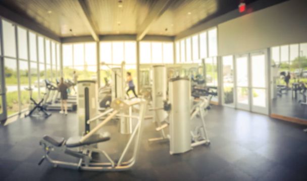 Panoramic blurry background open fitness center with people workout at new home community - Photo, Image