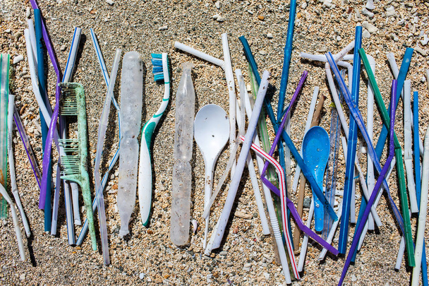 Haufen verschiedener Kunststoffabfälle: Strohhalme und Einweglöffel, - Foto, Bild