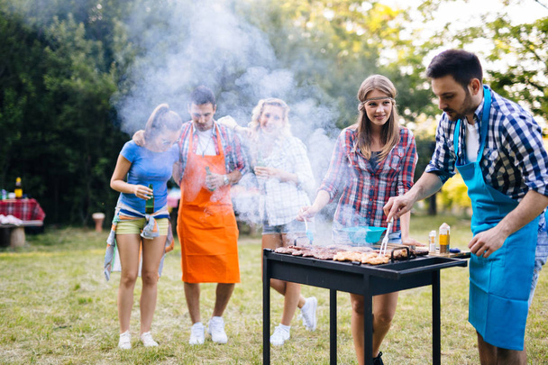 Young people having  bbq party in nature - Foto, Imagen