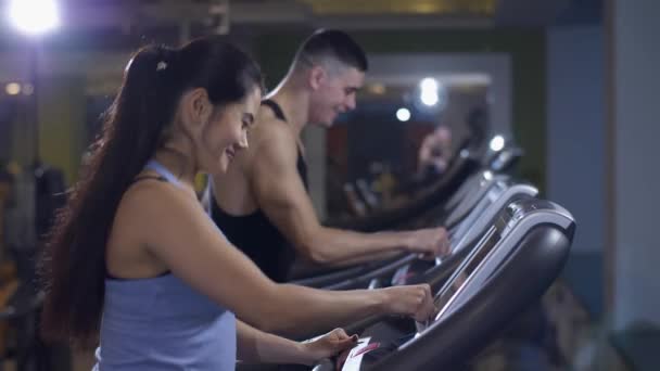 Man and woman on a treadmill - Кадри, відео