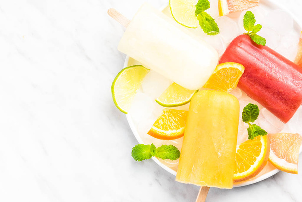 Orange,grapefruit and lime juice refreshing popsicles - Photo, Image