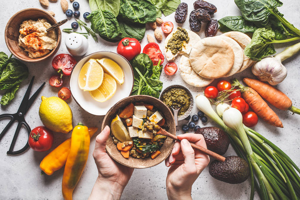 Healthy vegetarian food background. Vegetables, pesto and lentil - Фото, зображення