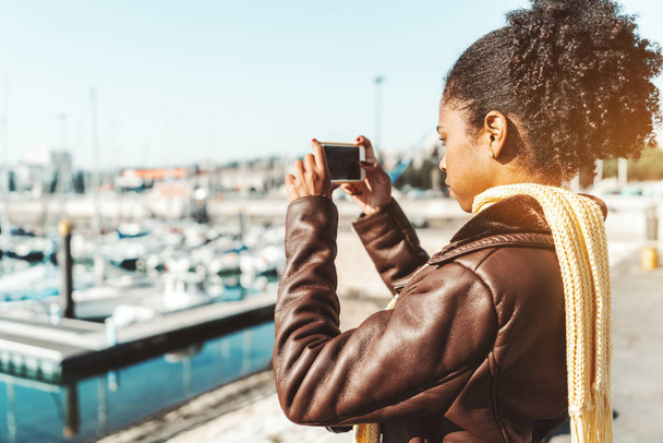 Biracial girl photographing wharf - Foto, immagini