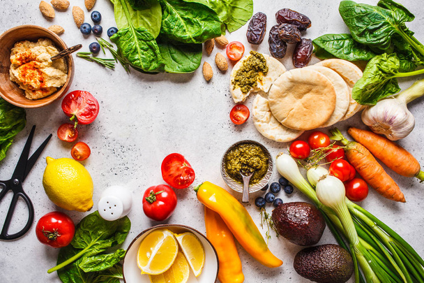 Healthy vegetarian food background. Vegetables, pesto and hummus - 写真・画像
