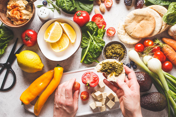 Cooking healthy vegetarian food background. Vegetables, pesto  - Foto, immagini