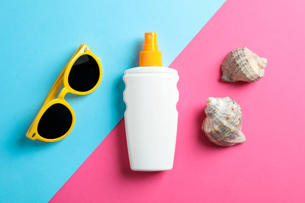 Flat lay composition with sunglasses, sunscreen pray and seashel - 写真・画像