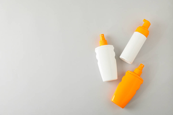 Flat lay composition with sunscreen sprays on grey background. S - Photo, Image