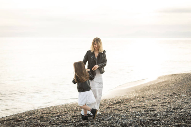 mother and daughter walking on the sea - Photo, image