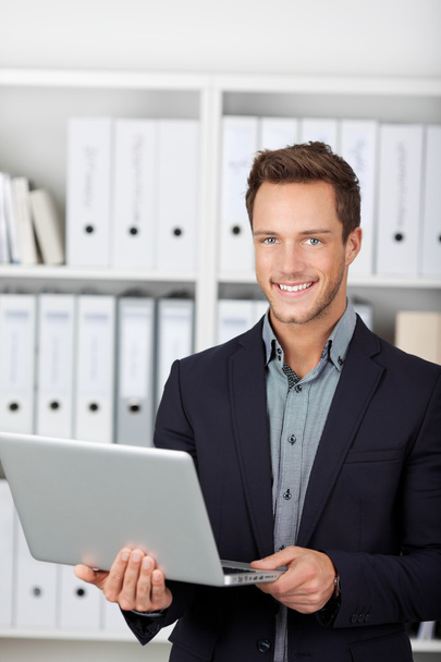 Smiling Businessman With Laptop In Office - Photo, image