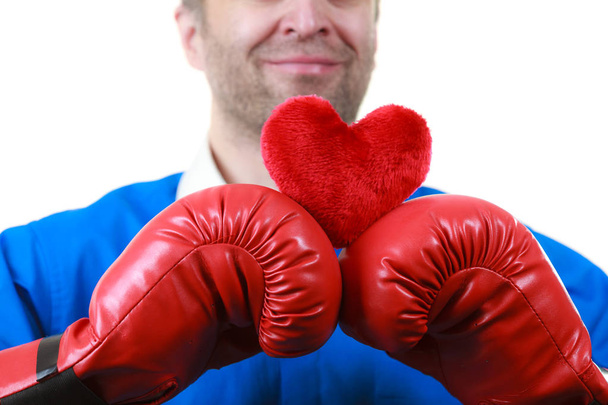 Man with boxing gloves holding heart - Zdjęcie, obraz