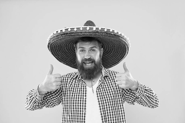 Maintain tradition. Mexican guy festive outfit ready to celebrate. Man bearded cheerful guy wear sombrero mexican hat yellow background. Mexican party concept. Celebrate traditional mexican holiday - Valokuva, kuva