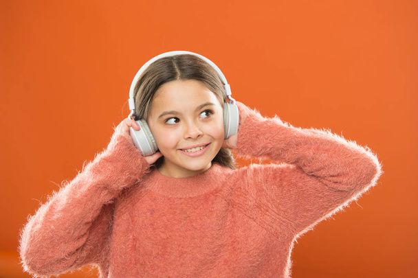 DJ, put the record on. Cute small child wearing DJ headphones. Little girl listening to music and dancing on silent disco in earphones. Adorable DJ girl. Enjoying music playing on DJ party - Photo, Image