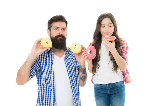 doughnut lover. Best day ever. That is just amazing. fathers day. childrens day. family bonds. having fun. father and daughter eat doughnut. happy little girl with father. little child love dad. diet - Foto, imagen