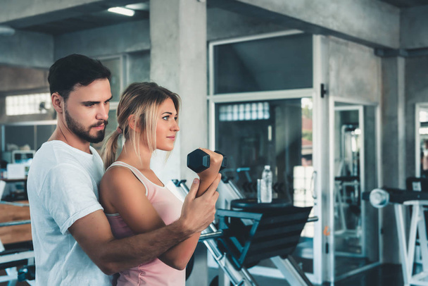 Portrait of Couple Love in Fitness Training With Dumbbell Equipment., Young Couple Caucasian are Working Out and Training Together in Gym Club., Sport and Healthy Concept. - Photo, Image