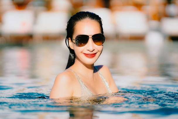 Portret piękny młody Asian Woman uśmiech szczęśliwy relaks wokół basen w Hotel Resort dla przyjemności podróży i koncepcji wakacje - Zdjęcie, obraz