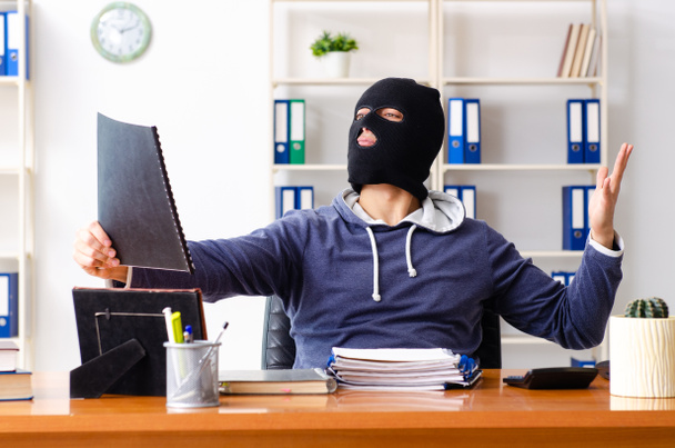Male thief in balaclava in the office  - Photo, Image